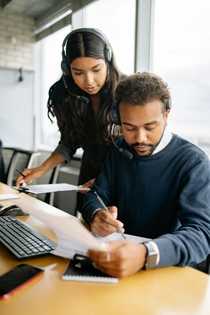 Business professionals collaborating in a call center environment, focusing on customer service solutions.